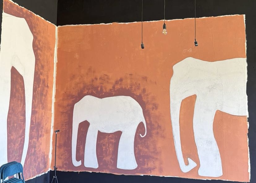 Warm terracotta mural inside Madeira Creative House